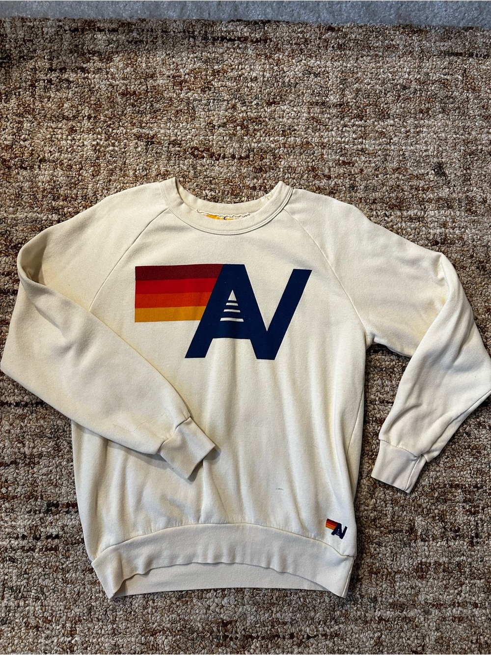 Aviator Nation Cream Crewneck with Navy 'AN’ and Retro Red-Orange-Yellow Stripe